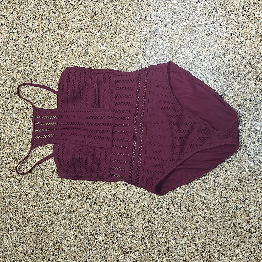 Ladies Kenneth Cole one piece swimsuit. High neck halter with crocheted cutouts.